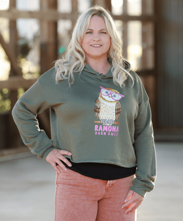 Woman Wearing Military Green Cropped Hoodie with Pink Logo