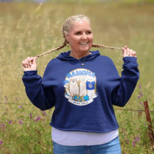 Woman in navy 5 Guys crop lightweight hoodie with braids and cap